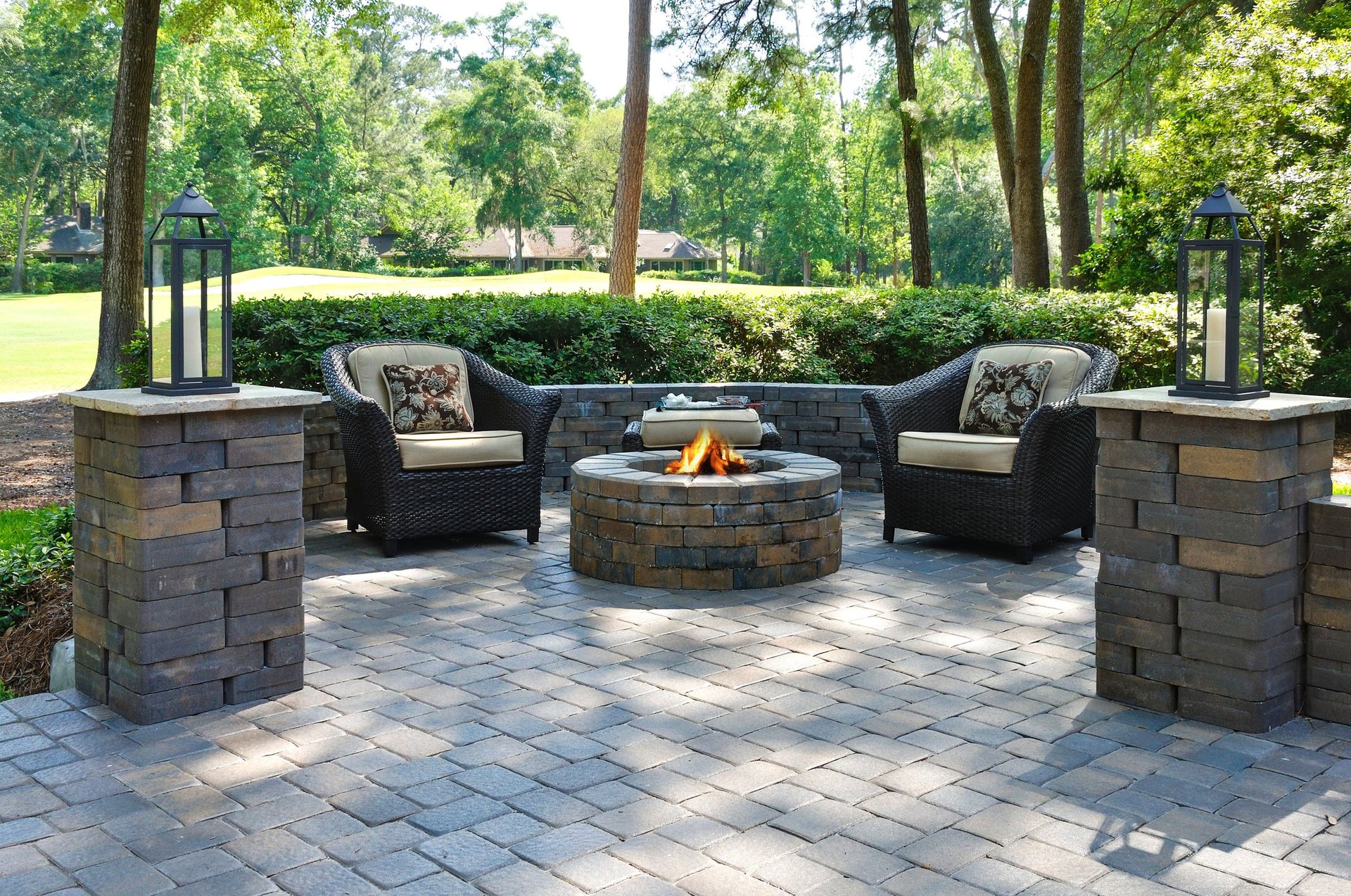 A beautiful outdoors with comfortable armchairs and a fire pit