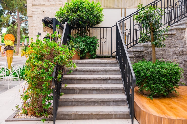 Stone staircase with black metal railing
